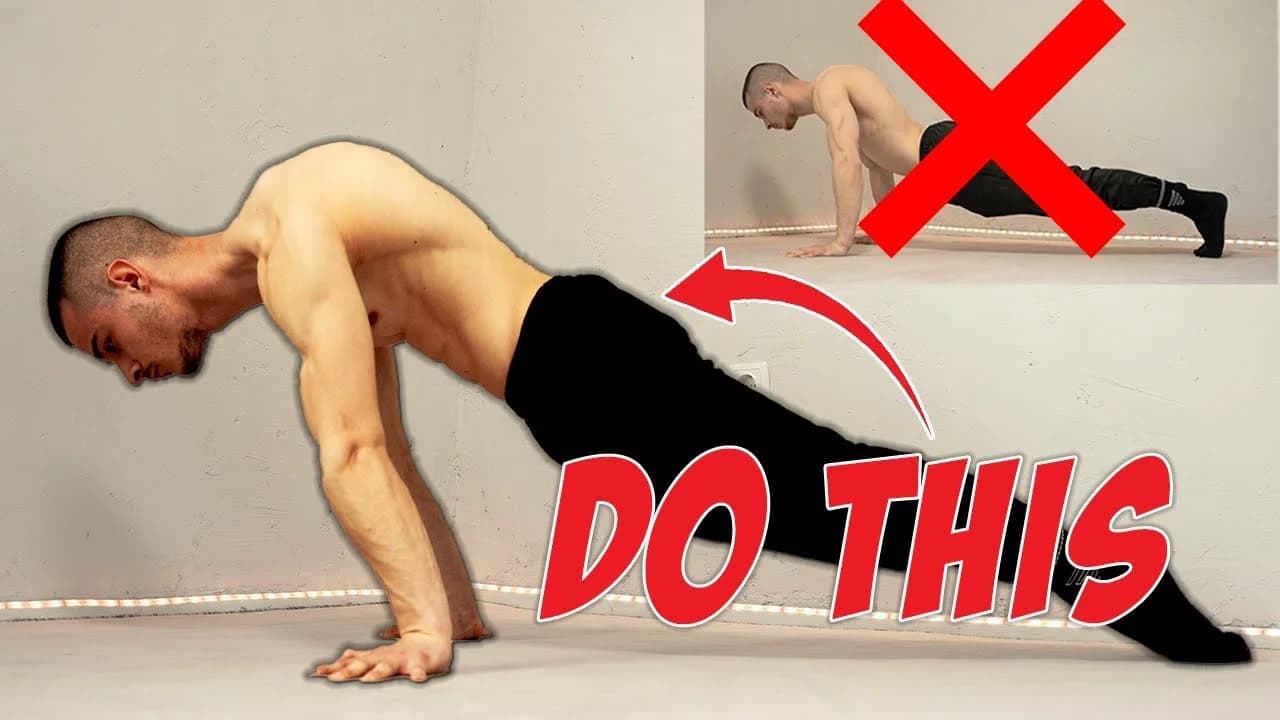 Daniel Hristov demonstrating a straight-arm planche lean hold on the floor during a beginner tutorial