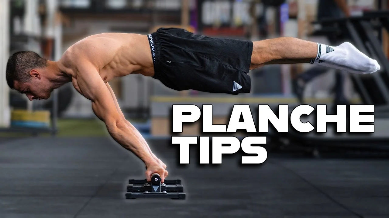 Daniel Hristov demonstrating correct planche lean form with straight elbows and shoulder protraction on parallettes