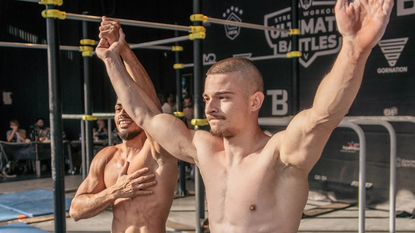 Daniel Hristov raising his arms in victory after winning a street workout battle