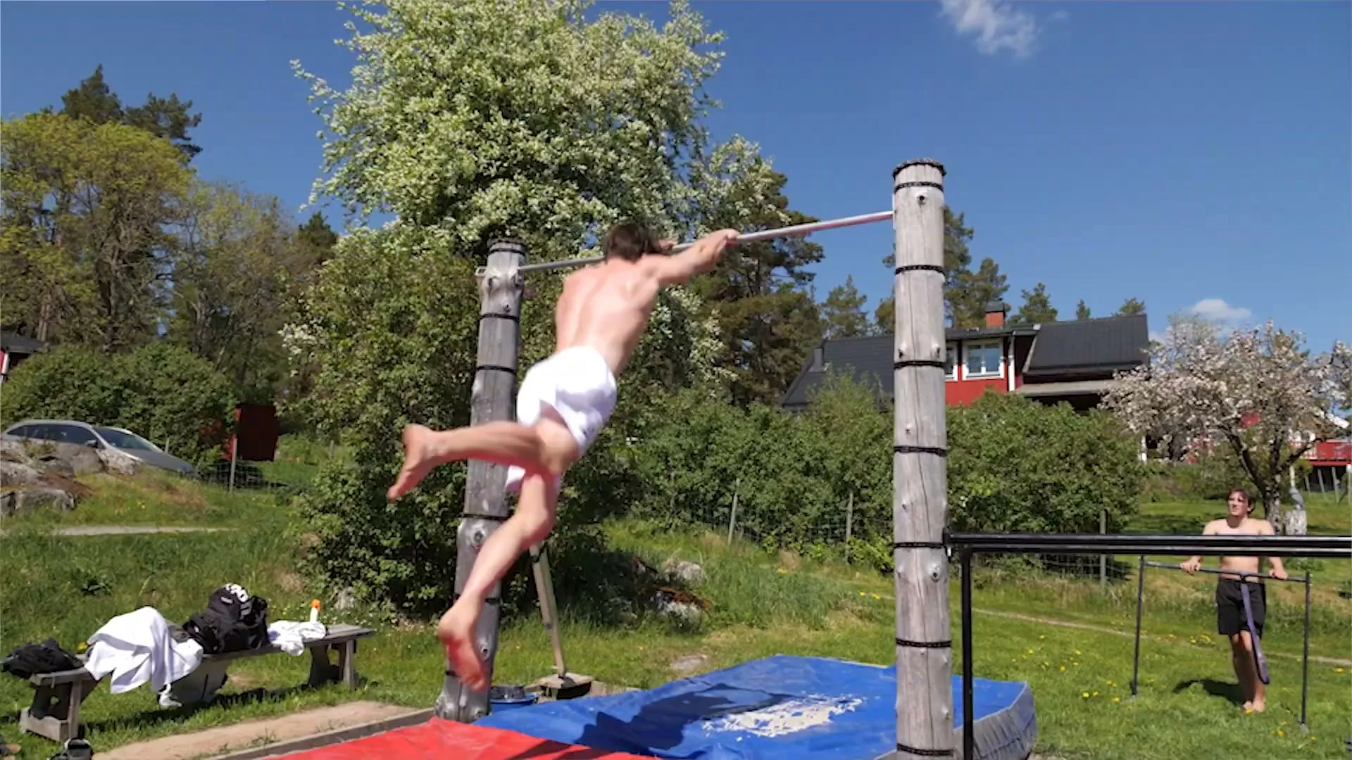 Daniel Hristov kicking into a dynamic rotation on an outdoor bar with full arm extension