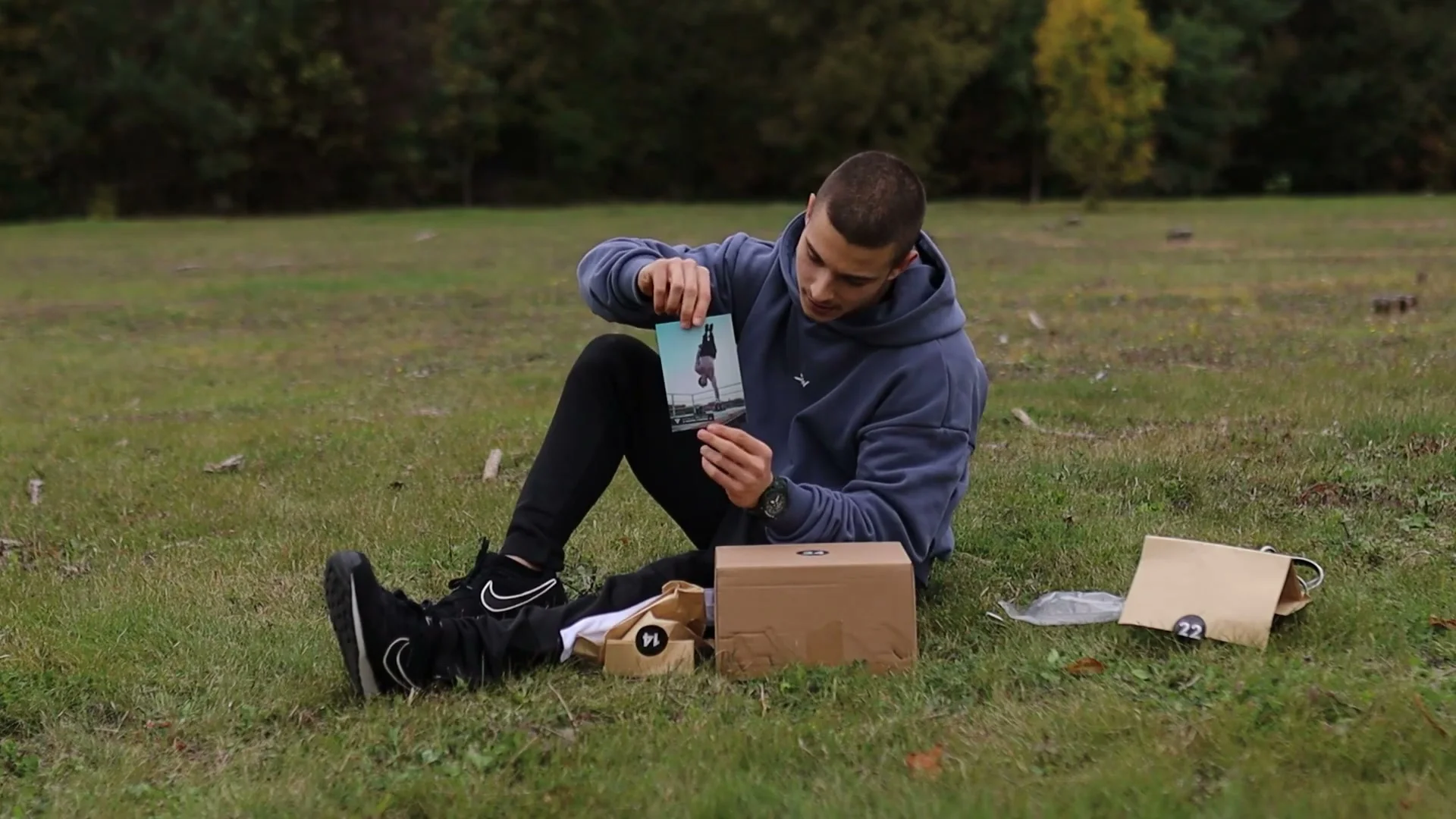 Daniel Hristov holding a printed card with a QR code and handstand photo for the Vitaliy Melnychenko routine
