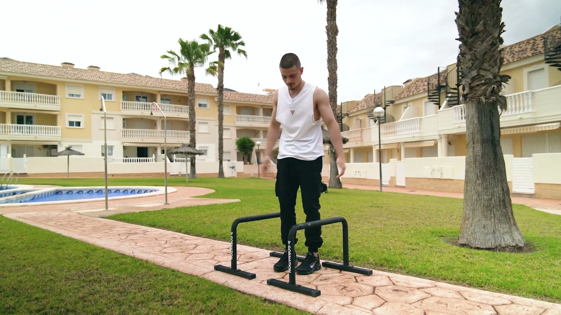 Daniel Hristov standing on top of the GORNATION metal parallettes to test their height and stability