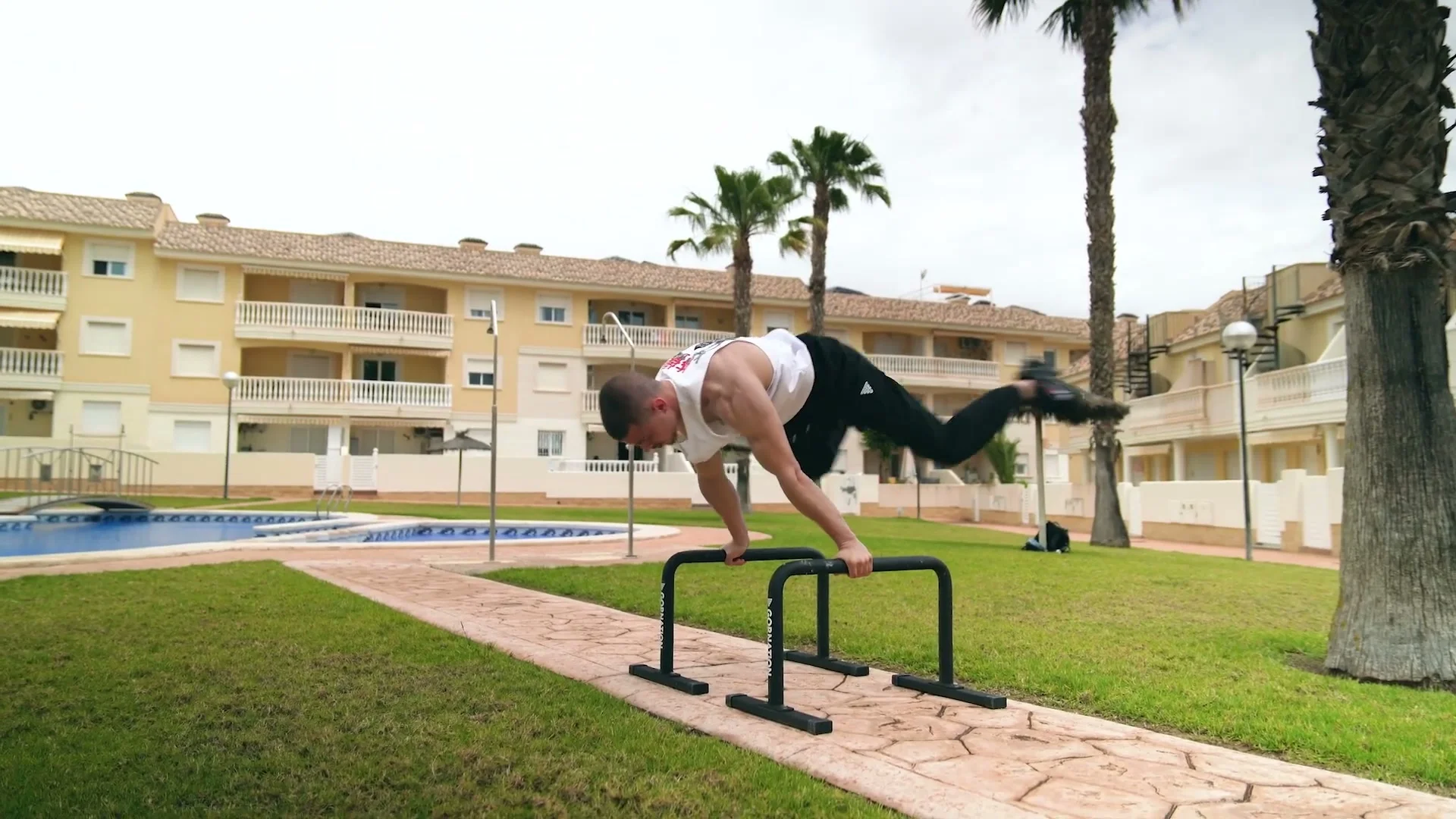Daniel Hristov transitioning through a planche press on the GORNATION metal parallettes