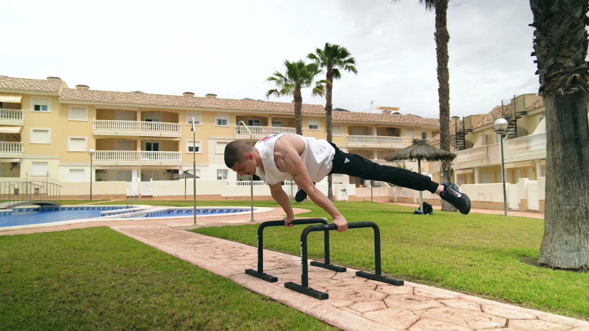Daniel Hristov holding a full planche position on the GORNATION metal parallettes