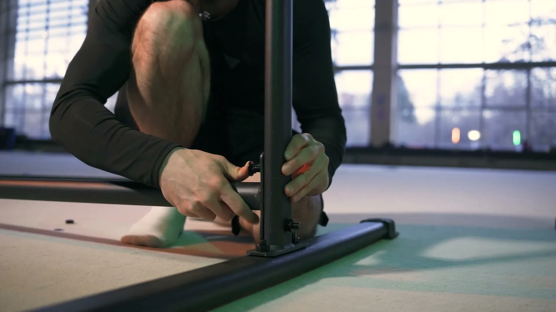 Daniel Hristov bolting the bottom bar section onto the Gornation Static Bar 2 frame during assembly