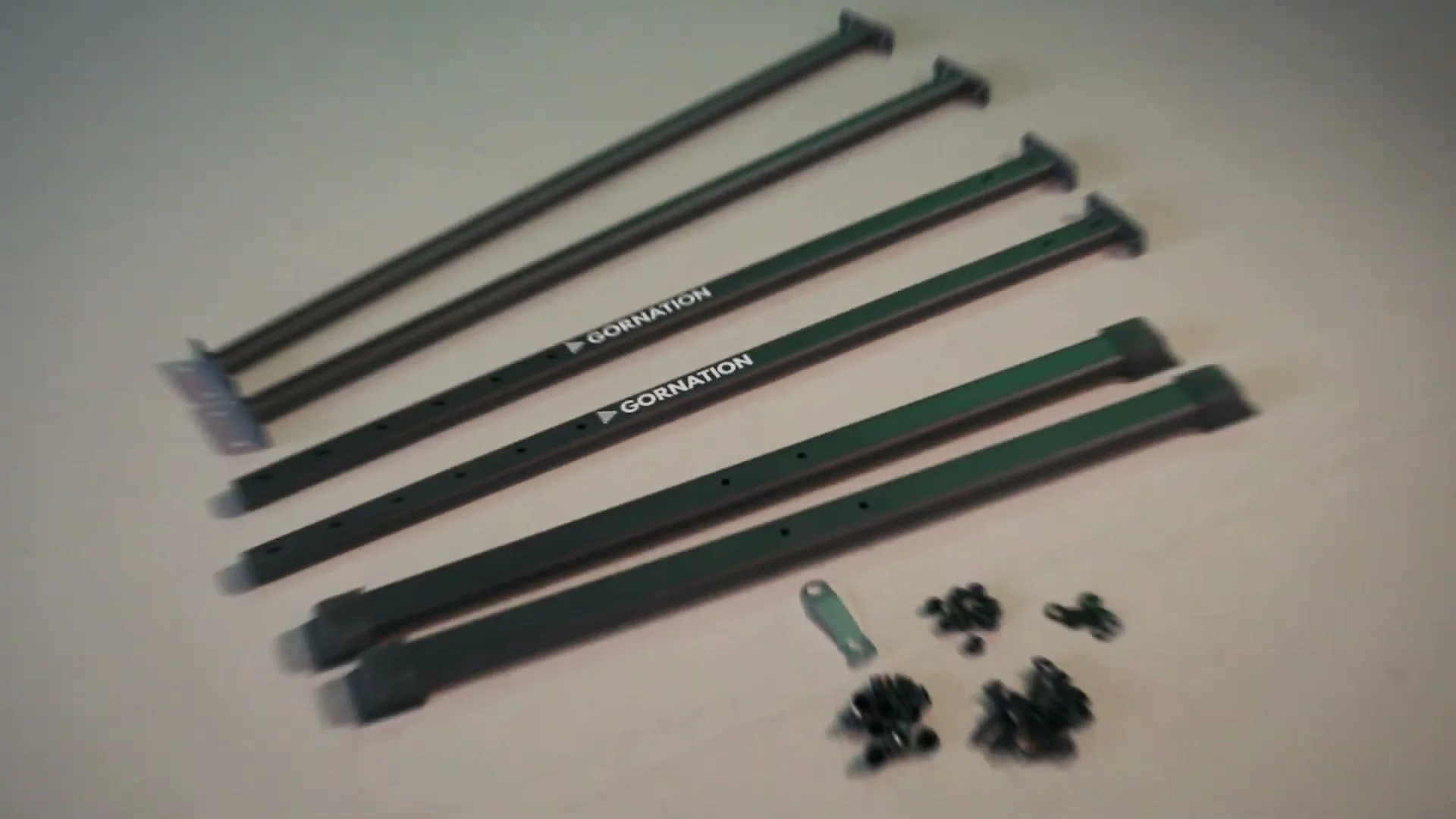 All Gornation Static Bar 2 parts laid out on the floor after unboxing, including both bars, feet, and bolts