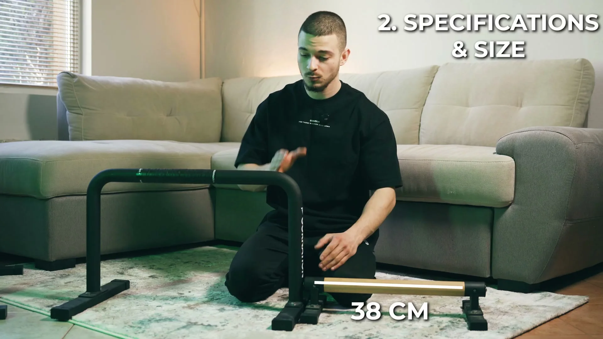 Daniel Hristov kneeling next to the wooden parallette bar with a measurement overlay showing 38 centimeters